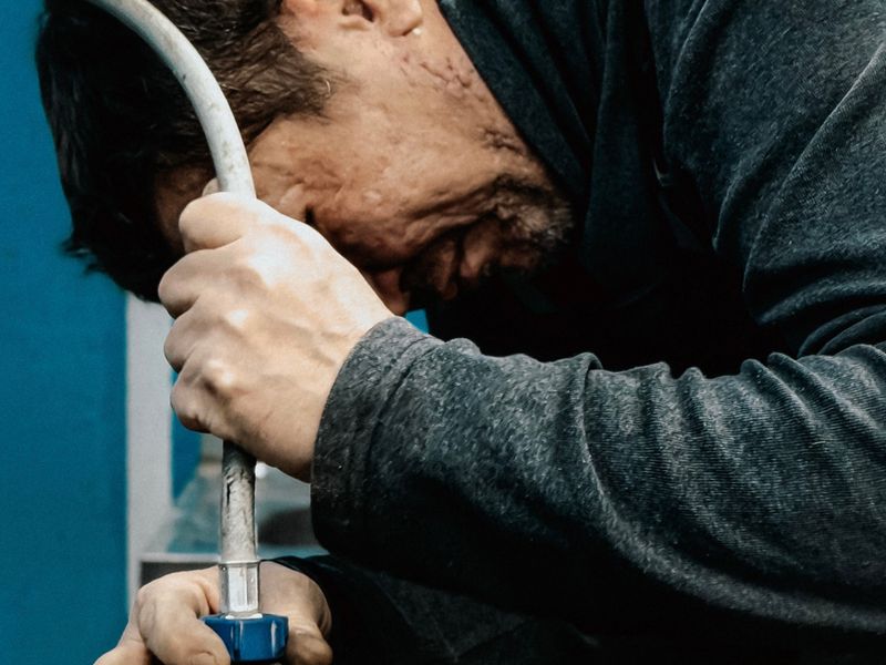 A technician adjusting a household water pump